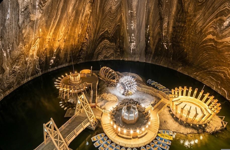 Underground lake at the Terezia Mine with wooden platforms and rowboats, Salina Turda